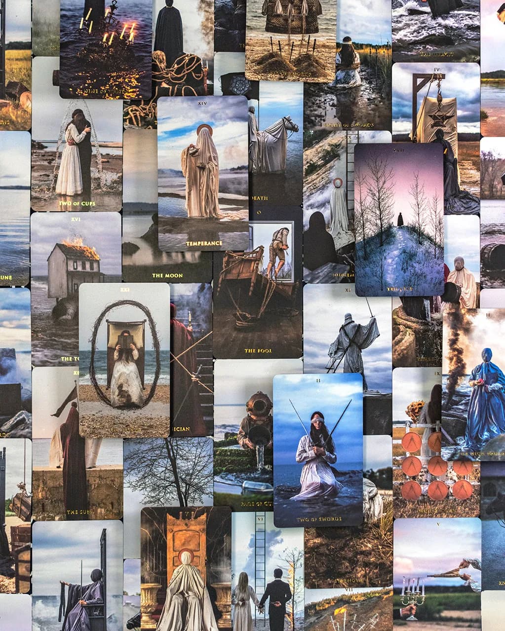Dense grid collage of Somnia Tarot cards laid edge to edge, repeating cloaked figures, coastal water and rope imagery throughout